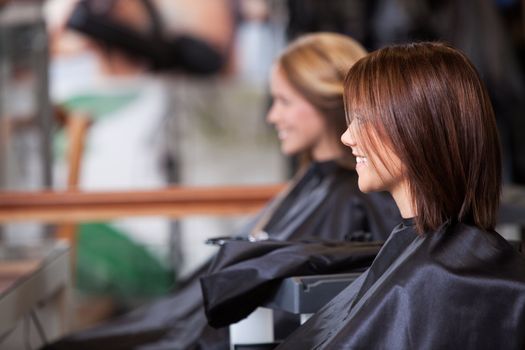 Women sitting in beauty salon.