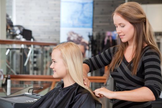 Hairdresser and client in beauty salon.