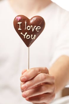 man with chocolate heart in the hands