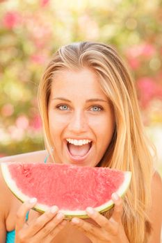 Portrait of a beautiful young woman eating watermelon