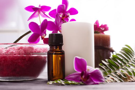 Beauty spa settings with oil, salt and orchids