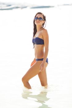 sexy beautiful model on bikini posing in the water