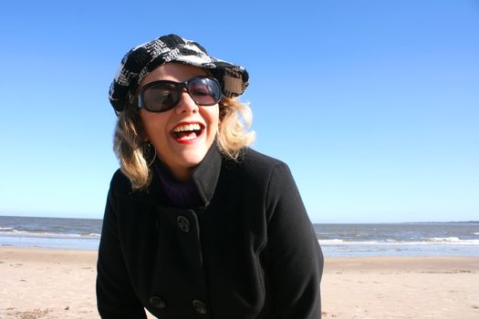 Portrait of a mature woman enjoying the sunlight on a beach.