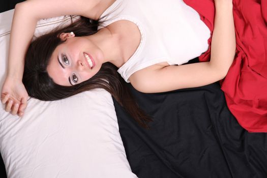 A young hispanic Woman sleeping on the Bed.
