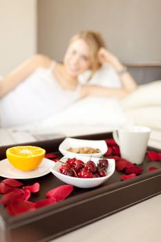 cherries detail in a women breakfast on bed