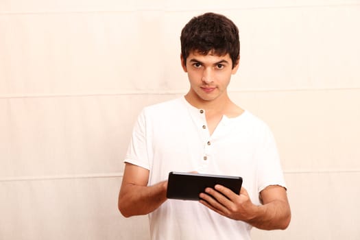 A young hispanic man using a Tablet PC.