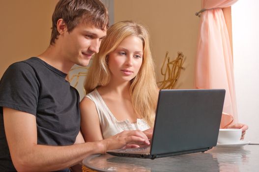 Young couple in the cafe with laptop