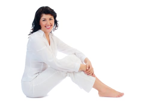 Young smiling woman sitting on floor isolated