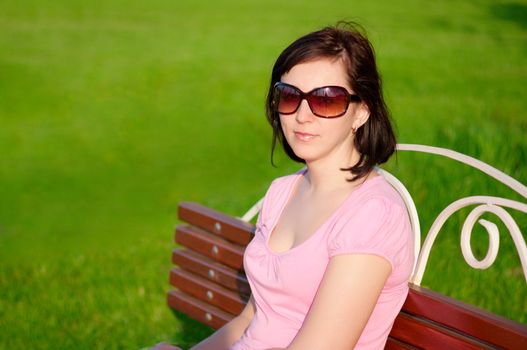 Young smiling woman on a bench