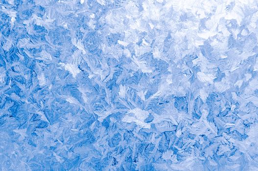 Light blue frozen window glass background