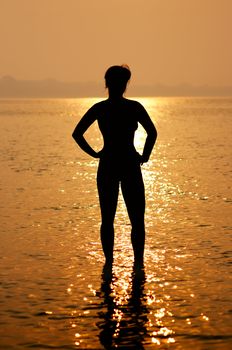 Silhouette of young woman in the sea