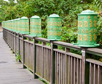 Green plastic roadside prayer wheels in Taiwan