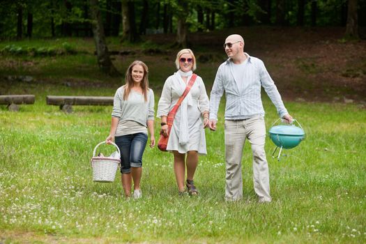 Full length portrait of group of friends out for a bbq picnic