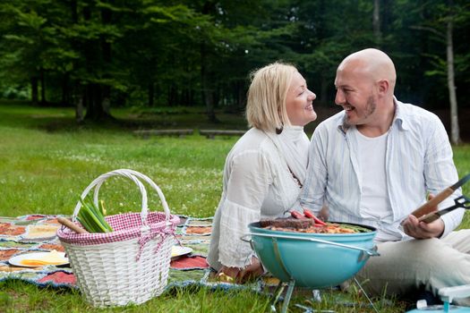 Happy Couple in Park with Barbecue