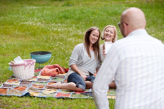 Friends in park having a BBQ and taking pictures