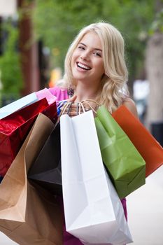 Portrait of happy smiling yougn woman with shopping bags