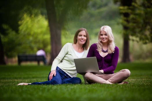 Young Women Using laptop in park.