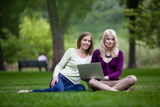Young Women Using laptop in park.
