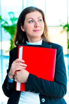 Encouraged by a businesswoman holding a red folder with documents on background of office interior