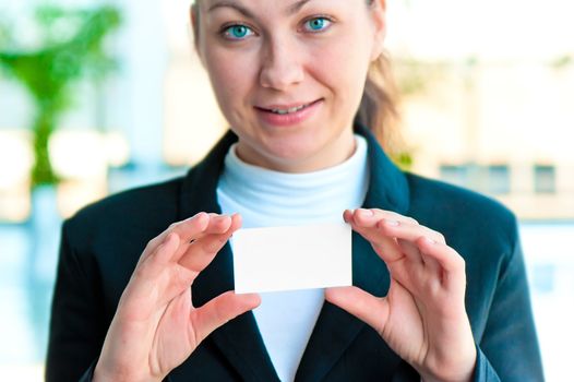 The smiling girl the manager holds the empty business card before herself