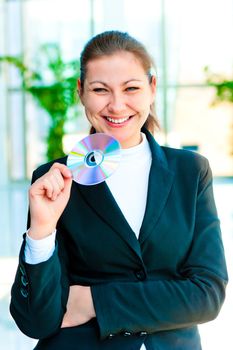 Young happy business woman holding compact disc