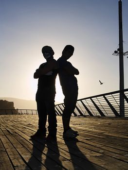 Silhouettes of poses of two rappers