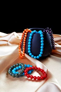 Bracelets and beads on a golden fabric