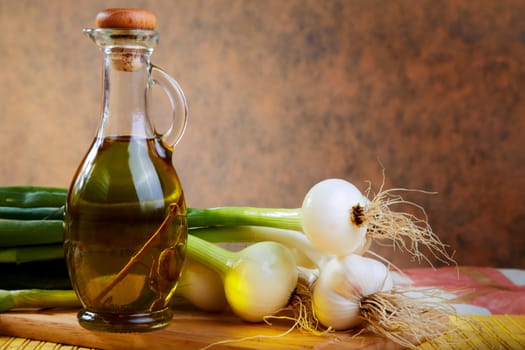 Onion and garlic with an olive oil bottle
