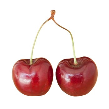 Two cherries on white background