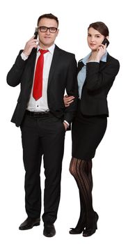 Young business couple using mobile phones isolated against a white background.