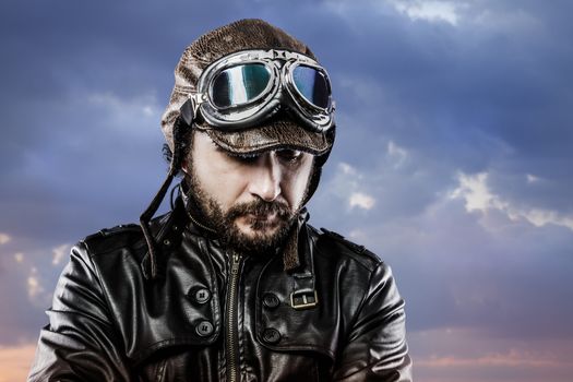 pilot with glasses and vintage hat with proud expression over cloudscape