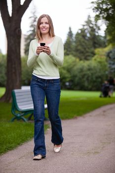 Woman Using Cell Phone in park.