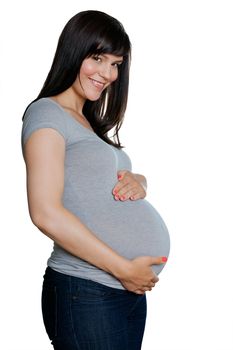 Portrait of happy pregnant woman with hands on stomach isolated over white background