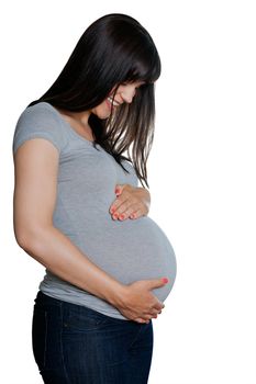 Happy pregnant woman with hands on stomach isolated over white background