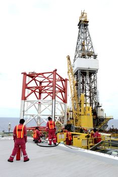 The helicopter landing officer checking fuel before refuel to helicopter at offshore oil rig