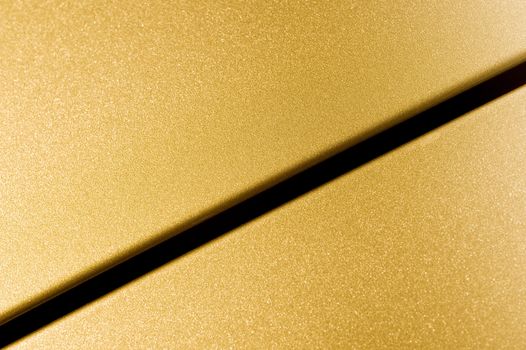 glittering golden vehicle panel closeup