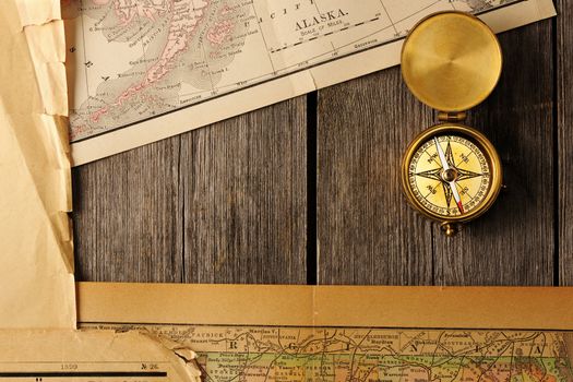 Antique brass compass over old map