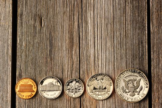 Five US cent coins over wooden background