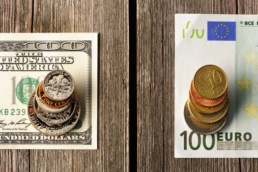 US and euro currency over wooden background