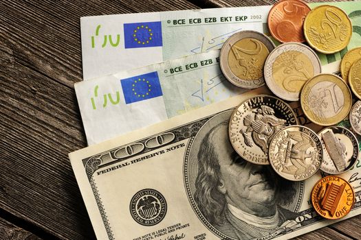 US and euro currency over wooden background