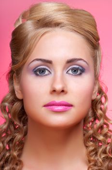 Portrait of young woman on pink background