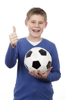 Young boy holding a football ball on white background