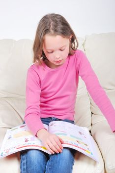 Girl student on the couch with a notebook