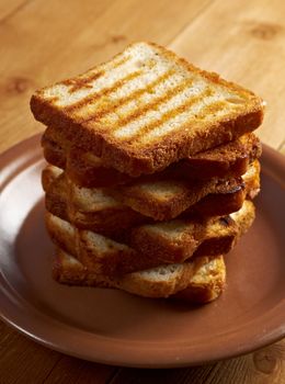 pile  toasted bread slices for breakfast.Close up of toasted white bread in slices