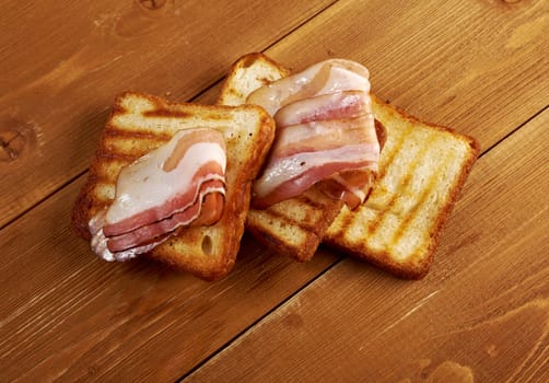 pile  toasted bread slices for bacon.Close up of toasted white bread in slices