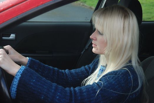 woman driving a red car