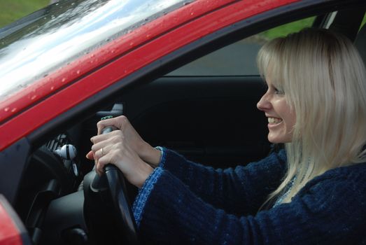 woman driving a red car