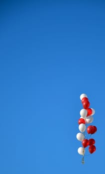 The sky background with a bunch of red and white balloons