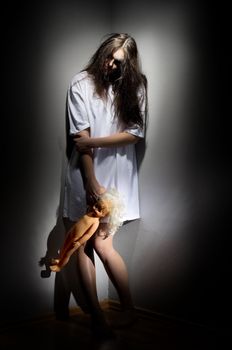 Zombie girl with plastic doll