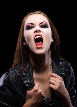 Young beautiful vampire woman on black